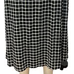 Elegant black and white checkered maxi skirt, perfect for casual or formal wear, featuring a comfortable fit and stylish pattern.