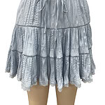 Light blue tiered ruffle skirt with elastic waistband and drawstring, perfect for casual summer wear and beach outings.