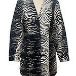 Stylish women's coat with bold zebra print in black and white, perfect for fashionable winter or fall wear.
