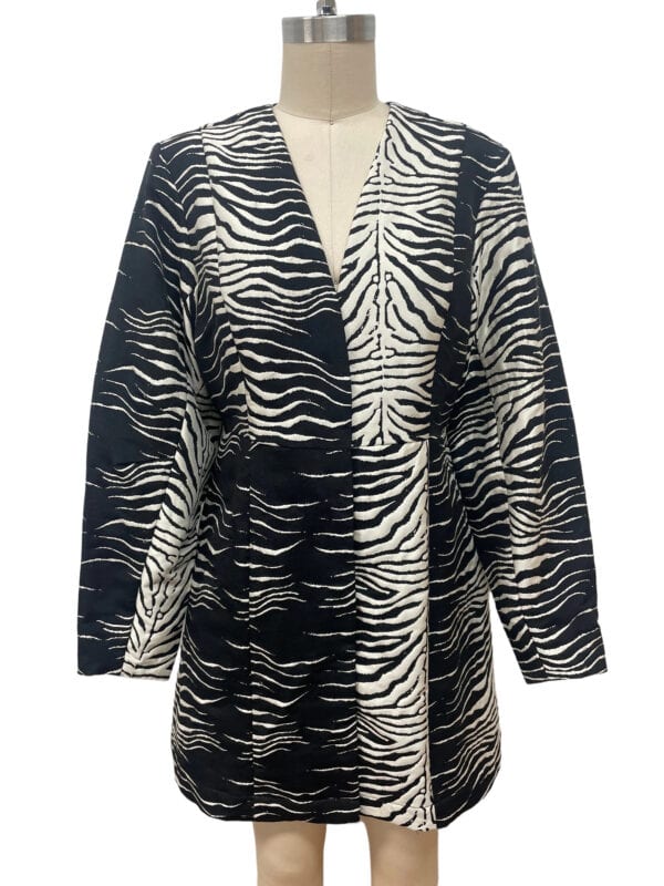 Stylish women's coat with bold zebra print in black and white, perfect for fashionable winter or fall wear.