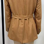 Stylish brown pinstripe blazer with a waist belt, perfect for professional or casual wear, displayed on a mannequin against a white background.