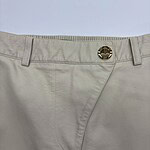 Close-up of beige casual men's pants with a metal button and belt loops, suitable for everyday wear and fashion.