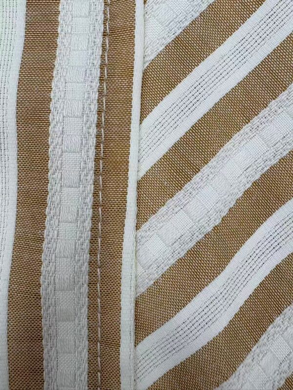 Close-up of striped fabric with white and beige tones, showcasing detailed weaving and texture, ideal for fashion and textile design.