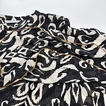 Luxurious black and white animal print pajamas with gold piping, perfect for stylish loungewear or sleepwear, showcasing comfort and fashion.