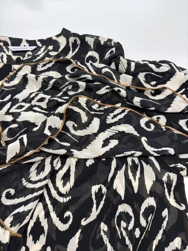 Luxurious black and white animal print pajamas with gold piping, perfect for stylish loungewear or sleepwear, showcasing comfort and fashion.