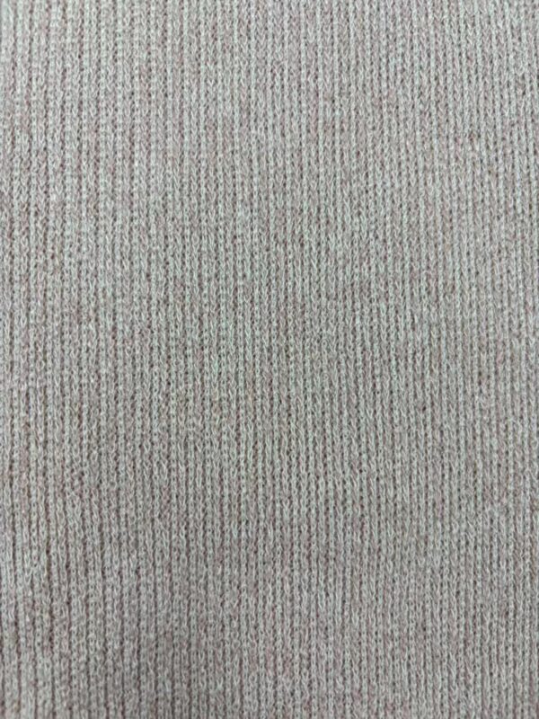 Close-up of beige ribbed fabric texture, ideal for clothing and fashion design.