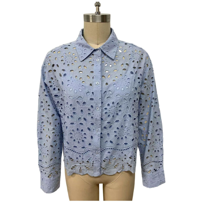 Light blue eyelet embroidered jacket with a classic collar and long sleeves, displayed on a mannequin for fashion showcase.