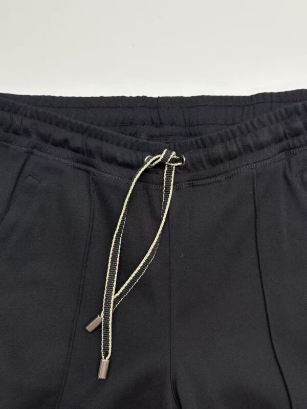 Close-up of black jogger pants with drawstring waist, suitable for casual and athletic outfits.