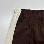 Close-up of stylish casual sweatpants with elastic waistband, beige and dark brown colors, suitable for comfortable everyday wear.