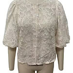 Elegant cream lace blouse with puff sleeves and intricate floral pattern, perfect for formal or special occasions.