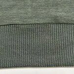 Close-up of green fabric with two different textures, one smooth and the other ribbed, suitable for clothing or upholstery.