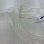 Close-up of a white sweater with a ribbed neckline, showcasing high-quality knit fabric suitable for stylish casual wear.