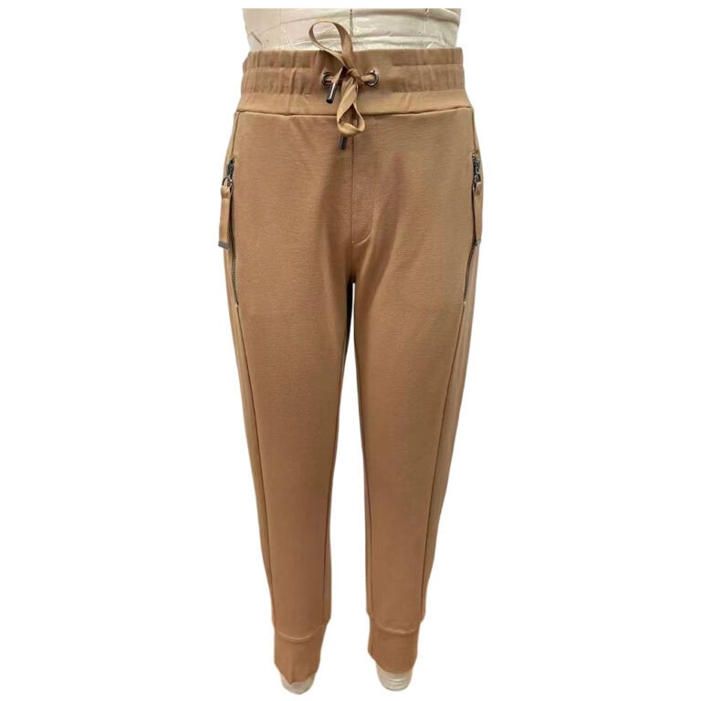 Tan jogger pants with zippered side pockets and drawstring waist, perfect for casual wear and comfortable fit.