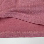 Close-up of pink fabric with glittery texture, suitable for clothing and fashion accessories.