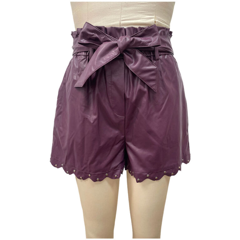 Stylish purple leather shorts with a high waist and a bow tie, featuring scalloped hem with metal stud details, perfect for fashion-forward outfits.