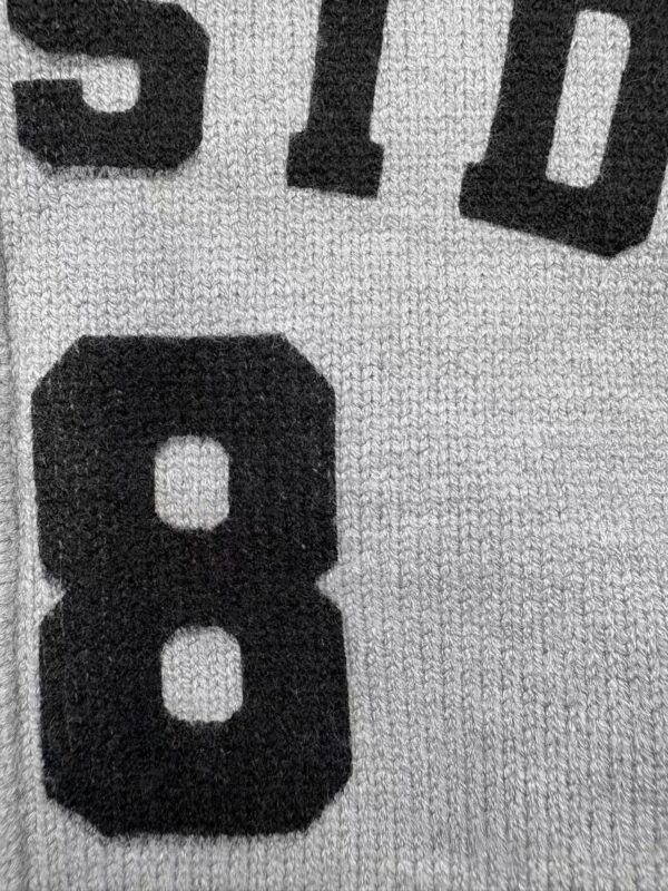 Detailed close-up of a sports jersey showing the number 8 in bold black font on a textured fabric background.