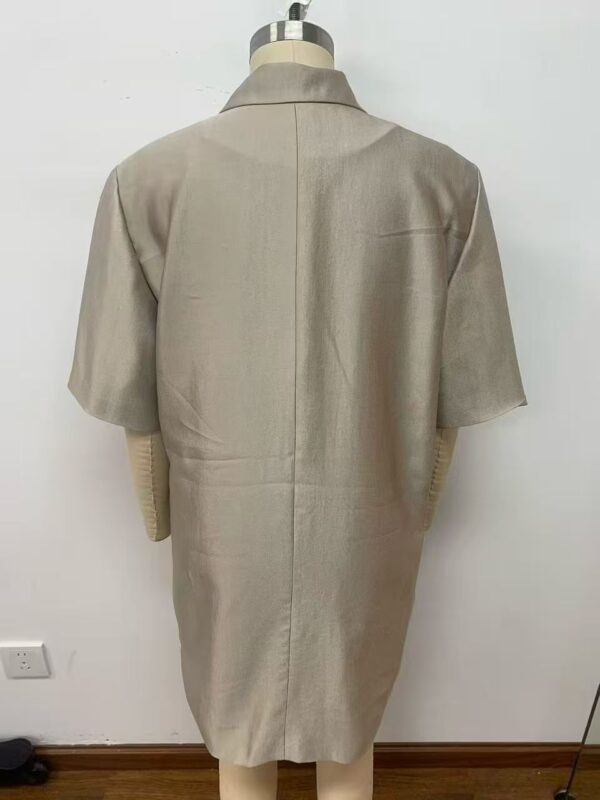 Stylish beige overcoat with a classic design, perfect for formal and casual wear, displayed on a mannequin against a plain background.