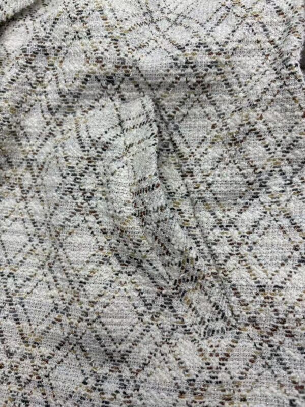 Close-up of snake print fabric showcasing intricate pattern and texture, ideal for stylish clothing and accessories.