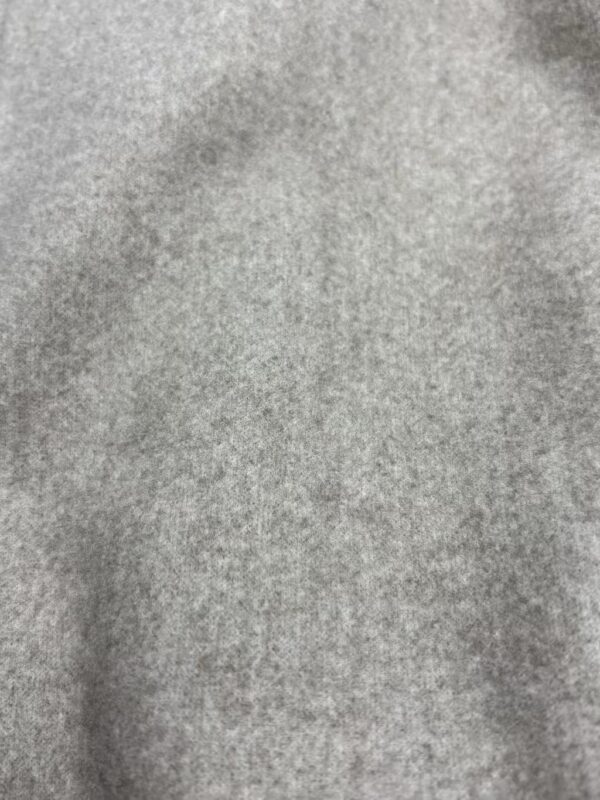 Close-up of soft grey fabric texture suitable for fashion and clothing design.