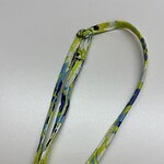 Vibrant fabric necklace with blue, green, and yellow patterns, perfect for stylish accessories and fashion statements.