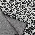 Close-up of stylish leopard print fabric with a smooth texture, perfect for fashion and apparel design.