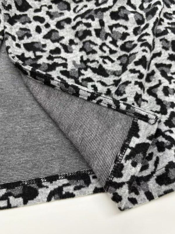 Close-up of stylish leopard print fabric with a smooth texture, perfect for fashion and apparel design.