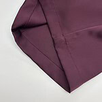 Close-up of burgundy fabric with detailed stitching, ideal for high-quality fashion garments and apparel.