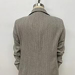 A stylish women's blazer in a classic grey check pattern, perfect for professional or formal occasions, displayed on a mannequin against a plain white background.