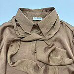 Beige silk blouse with matching scarf, stylish and sophisticated fashion piece for women.