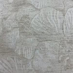 Close-up of light gray linen fabric with subtle leaf pattern, ideal for fashion and home decor projects.