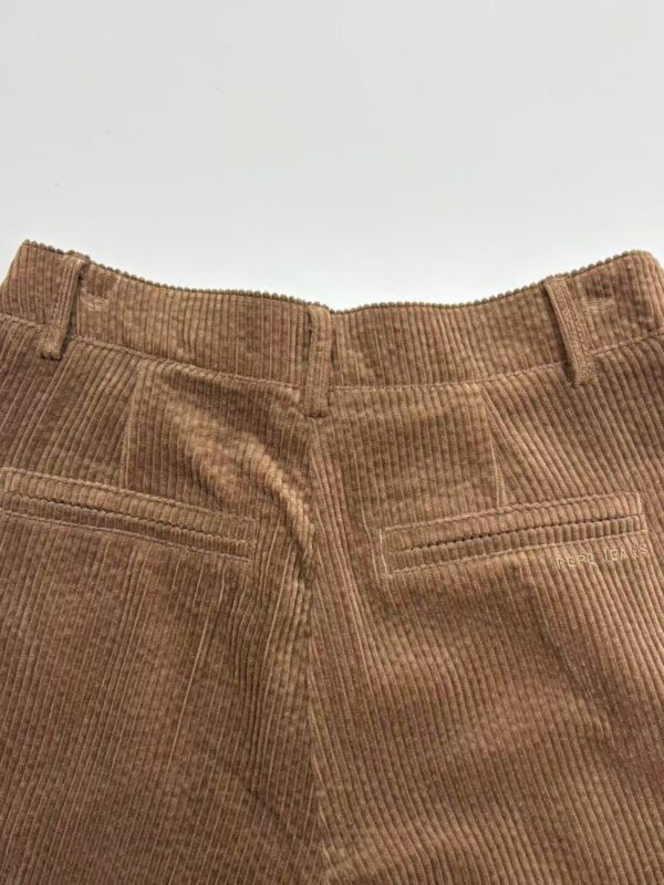Close-up of brown corduroy pants showing back pockets and waistband, suitable for casual or semi-formal wear.