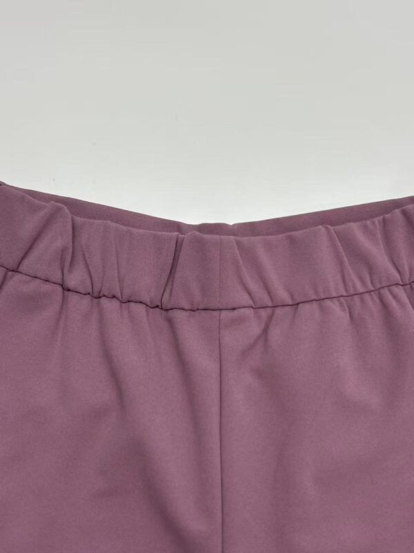 Close-up of a stylish pink skirt with an elastic waistband, perfect for casual or semi-formal wear, showcasing high-quality fabric and craftsmanship.