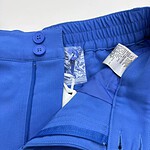Close-up of vibrant blue men's sports shorts with elastic waistband and zipper pocket, ideal for athletic activities and casual wear.