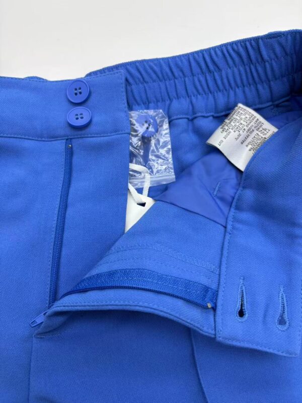 Close-up of vibrant blue men's sports shorts with elastic waistband and zipper pocket, ideal for athletic activities and casual wear.
