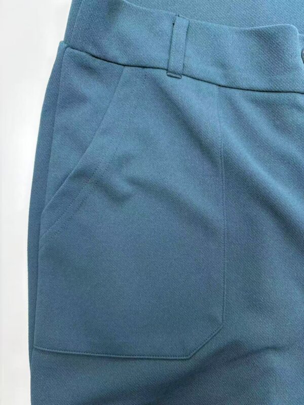 Close-up of blue men's pants showing fabric texture and pocket detail, perfect for casual or business wear.