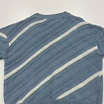 A blue knitted sweater with white diagonal stripes, featuring a crew neckline and ribbed hem, suitable for casual wear.