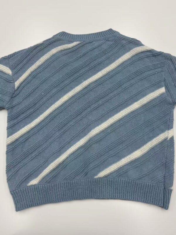 A blue knitted sweater with white diagonal stripes, featuring a crew neckline and ribbed hem, suitable for casual wear.