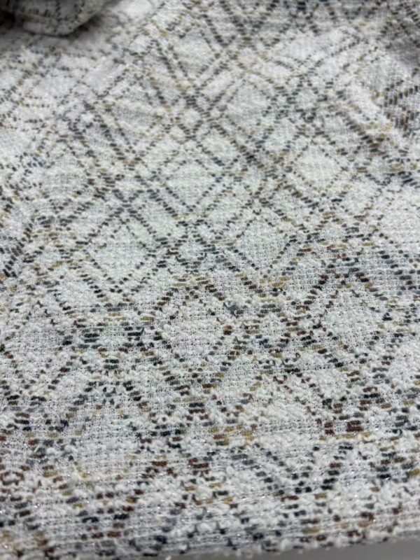 Close-up of a textured rug with a geometric diamond pattern in neutral tones, ideal for modern home decor.