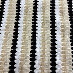 Close-up of striped knit fabric featuring black, white, and beige colors, showcasing textured pattern suitable for clothing and accessories.