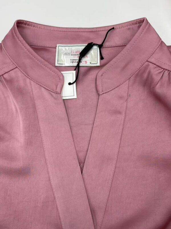 Stylish pink women's blouse with a mandarin collar and subtle pleats, perfect for casual or office wear, displayed on a white background.