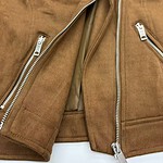 Close-up of two brown leather jackets with silver zippers, showcasing fashionable outerwear for men.
