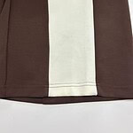 Close-up of a stylish brown dress with a contrasting cream panel, showcasing high-quality fabric and craftsmanship for fashion enthusiasts.