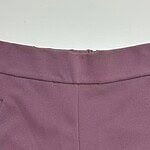 Close-up of a stylish mauve women's skirt with a smooth fabric finish and a subtle seam detail.