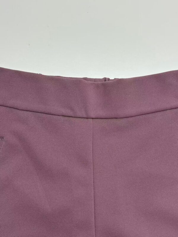 Close-up of a stylish mauve women's skirt with a smooth fabric finish and a subtle seam detail.