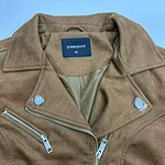 Close-up of a stylish brown leather jacket with silver zippers and snap buttons, perfect for men's fashion and casual wear.