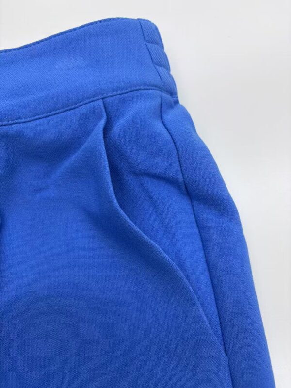 Close-up of vibrant blue casual pants showing waistband and pocket details, perfect for everyday wear and stylish comfort.