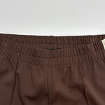 Close-up of brown casual pants with elastic waistband, suitable for everyday wear and comfortable fit.