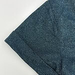 Close-up of a blue blazer with a subtle sparkle effect, showcasing the fabric texture and tailored sleeve design, perfect for fashionable office wear or evening outings.