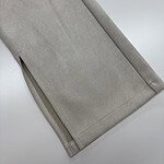 Close-up of beige pants with zipper detail at the hem, showcasing smooth fabric and clean stitching, ideal for fashion and clothing SEO.