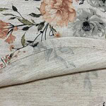 Close-up of floral fabric featuring pastel-colored flowers and soft, lightweight material suitable for fashion or home decor.